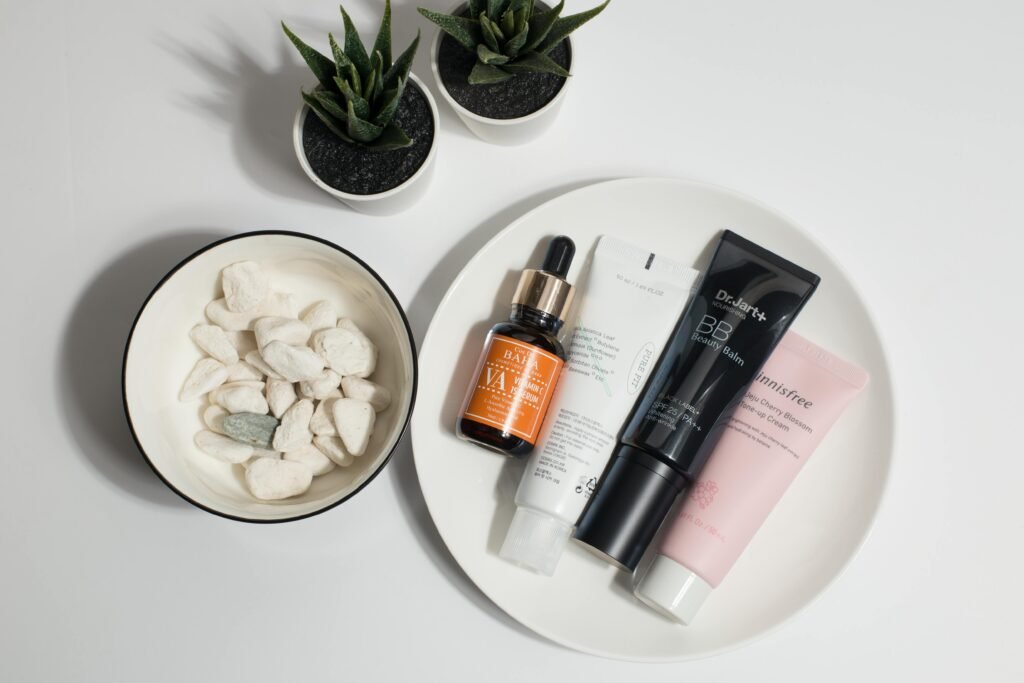 A flat lay of skincare products on a plate with decorative elements.